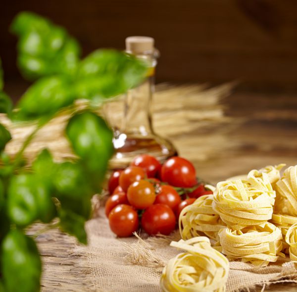 پس زمینه ایتالیایی مواد غذایی با گوجه فرنگی انگور ریحان اسپاگتی