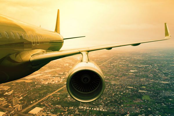 پرواز هواپیمای جت مسافربری که در بالای صحنه های شهری استفاده می شود برای حمل و نقل هوایی و کسب و کار سفر پیش زمینه است
