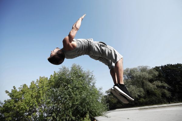 تناسب اندام ورزش پارکور و مفهوم افراد مرد جوان پریدن در پارک تابستانی
