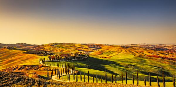 پانوراما حومه توسکانی تپه های تپه و زمینه های سبز در غروب خورشید ایتالیا اروپا