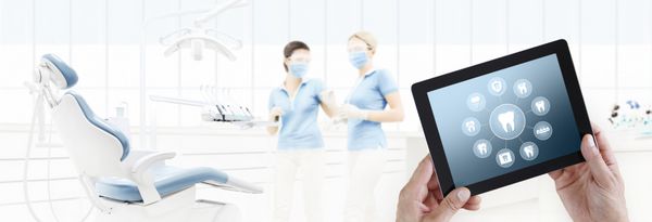 dentist hand touch digital tablet screen teeth icons and symbols on dental clinic with dentist