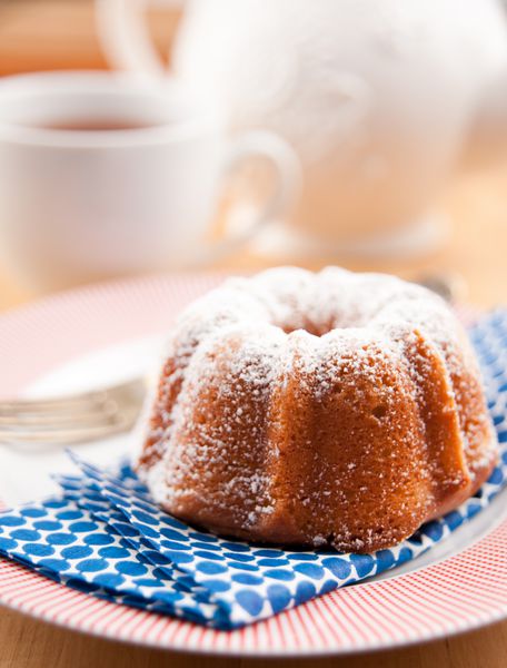 کیک کوچک کیک بوندت پودر شده با شکر و خامه ای با چای