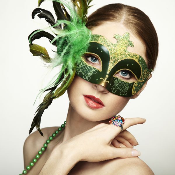 زن جوان زیبا در ماسک مرموز سبز ونیزی