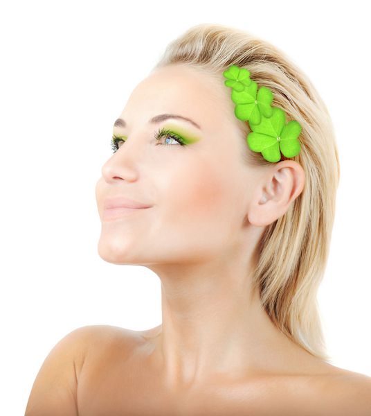 Beautiful woman with wreath of clover fresh green plant leaves in hair female face portrait isolated over white background pretty girl with bright makeup st Patrick