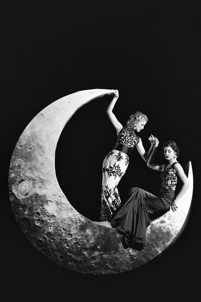 زنان جوان زیبا و دارای مو و لب قرمز در ماه هلال در لباس شب زیبا با توری با زمینه سیاه