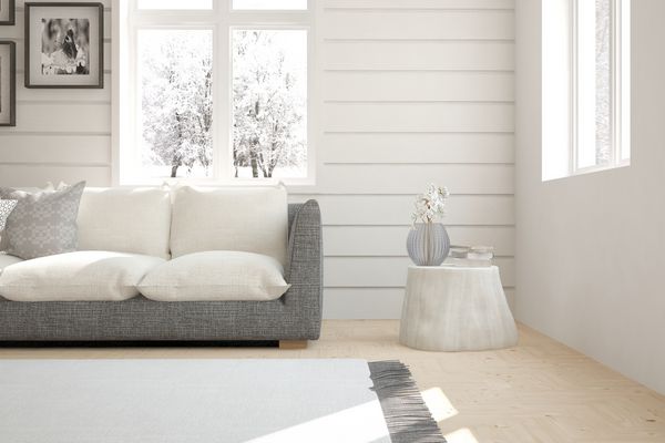 اتاق سفید با کاناپه و چشم انداز زمستانی در پنجره طراحی داخلی اسکاندیناوی تصویر سه بعدی