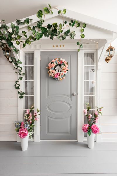 خانه کوچک چوبی سفید با درب خاکستری دکوراسیون گل بهار