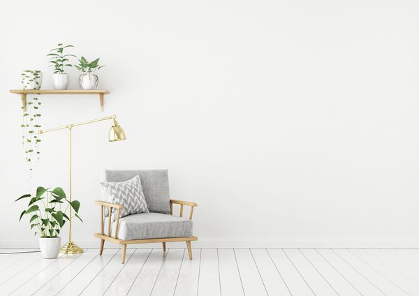 اتاق نشیمن سبک اسکاندیناوی با صندلی پارچه ای خاکستری لامپ طلایی و گیاهان با زمینه سفید خالی دیوار رندر سه بعدی