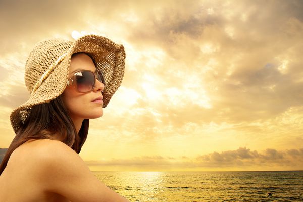 دختر در ساحل هنگام غروب آفتاب
