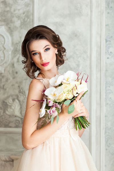 دختر جوان زیبا با یک دسته عروسی