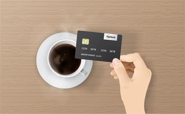 مرد تجاری که کارت اعتباری در دست دارد مرد تجاری در دفتر با قهوه داغ