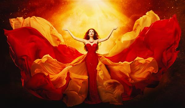 زنی با لباس پرواز بازوهای خود را به نور رمز و راز الهه فانتزی با لباس مجلسی قرمز بلند کرد