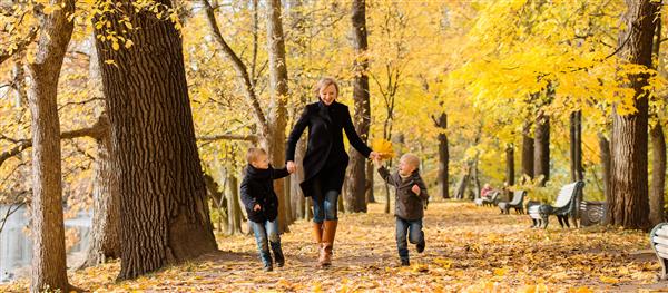 مادر و پسران در حال فرار در پارک پاییز خانواده خوشبخت