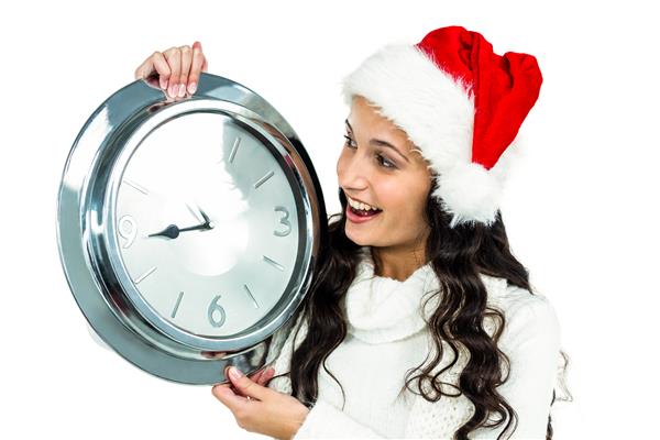 مدل زن با کلاه کریسمس که ساعت را روی صفحه سفید نگه داشته است