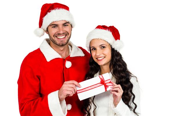 زن و شوهری با کلاه های کریسمس روی صفحه سفید در دست دارند