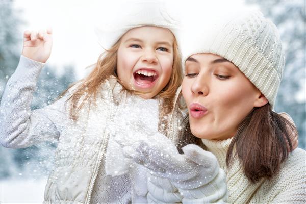 خانواده خوشبخت دختر مادر و کودک در حال قدم زدن زمستانی در طبیعت