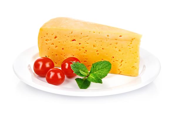 پنیر زرد در بشقاب با گوجه فرنگی و برگ سبز جدا شده بر روی زمینه سفید