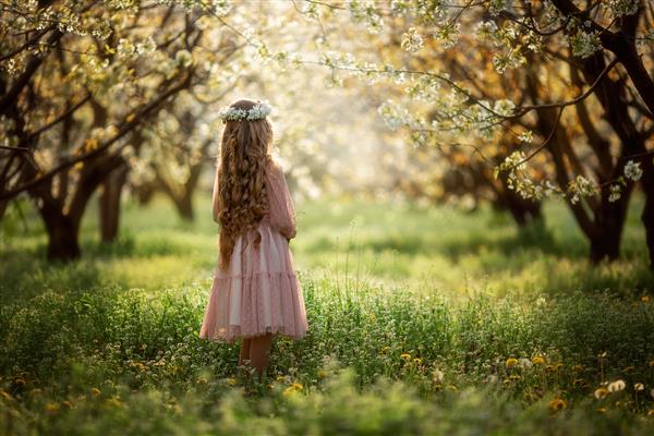 دختری با تاج گل در باغ شکوفه دار