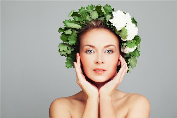 Spa beauty portrait of perfect woman with pretty face and wreath of green leaves