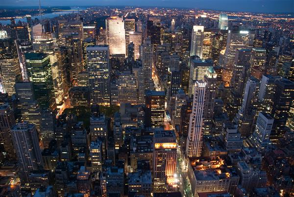 خط افق شهر نیویورک با آسمان خراش های شهری منهتن در غروب آفتاب