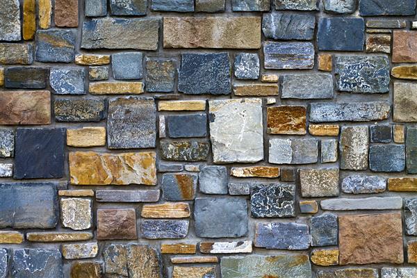 پس زمینه دیوار تزئینی ساخته شده از سنگ به شکل های مختلف نزدیک