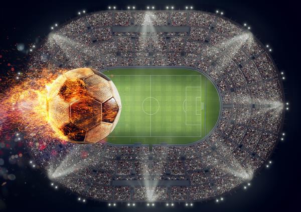 توپ فوتبال با شعله آتش بر فراز استادیوم