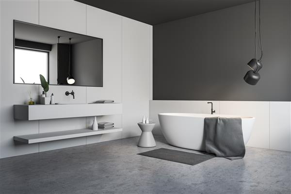 گوشه حمام شیک با دیوارهای سفید و خاکستری کف بتنی وان سفید با صندلی سفید در نزدیکی آن و سینک سفید با آینه افقی رندر سه بعدی