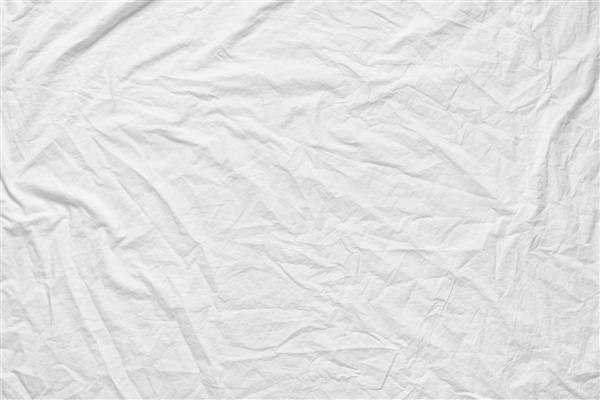 بافت چروکیده با بافت فابیک سفید پارچه سفید با فوکوس نرم مچاله شده از ملحفه ملافه استفاده از پس زمینه ما