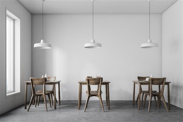 فضای داخلی رستوران سبک لفت با دیوارهای سفید کف بتنی پنجره باریک و میزهای چوبی تیره با صندلی و لامپ های شیک بالای آنها رندر سه بعدی