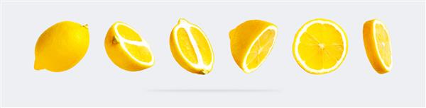 لیموهای زرد پرنده آبدار در پس زمینه خاکستری روشن مفهوم غذای خلاقانه میوه های ارگانیک گرمسیری مرکبات ویتامین C برش های لیمو پس زمینه میوه روشن مینیمالیستی تابستانی الگو