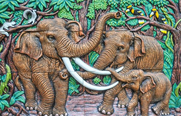 سارابوری تایلند - 03 نوامبر 2015 - کنده کاری روی چوب خانواده فیل ها