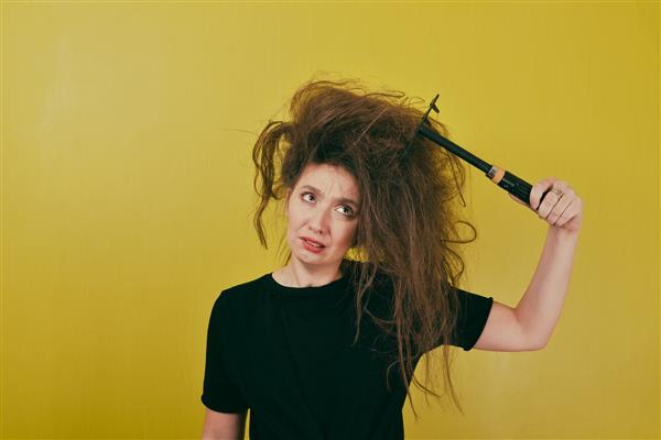 دختر عصبانی موهایش را با چنگک شانه می کند