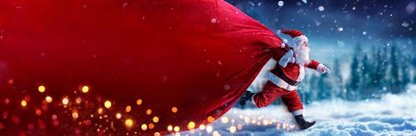 بابا نوئل با کیف بنر قرمز روی برف در زمستان - هدیه تحویل سریع