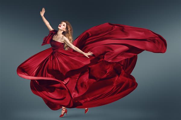 زن مد در حال رقصیدن با لباس بلند قرمز بال بال