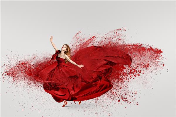 زن مد در حال رقصیدن با لباس بلند قرمز بال بال و ابری از پودر آرد