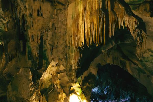 غار زیرزمینی تاریک طبیعی با استالاکتیت های عجیب و غریب