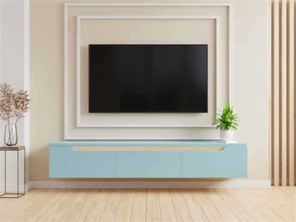 تلویزیون روی کابینت آبی در اتاق نشیمن مدرن در پس زمینه دیوار کرم رنگ رندر سه بعدی