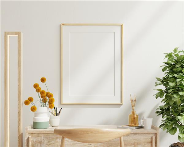 ماکت پوستر با قاب سفید عمودی در پس‌زمینه داخلی اتاق کار