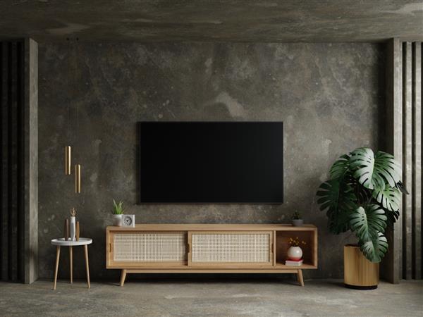 اتاق تلویزیون با رنگ‌های گرم خانه روی پس‌زمینه دیوار بتنی طراحی کمینه