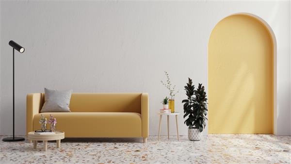 مبل زرد با گیاه روی دیوار سفید و کفپوش ترازو