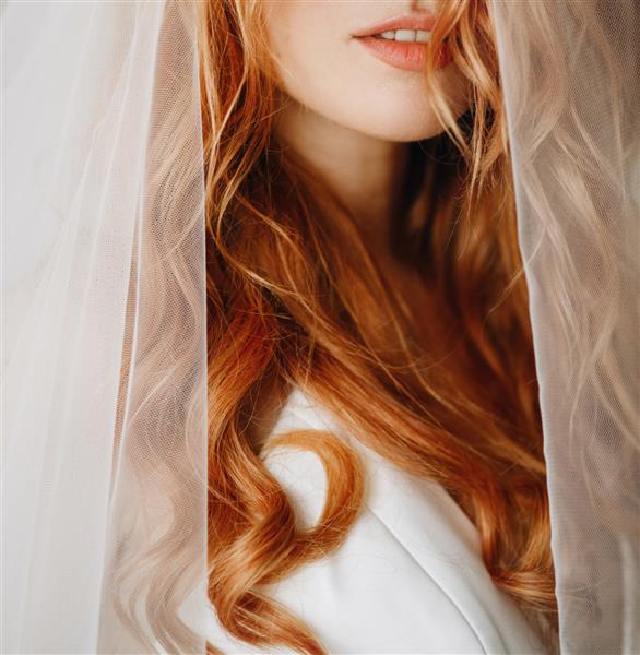 لب و پوست لطیف عروس جذاب با موهای مجعد قرمز