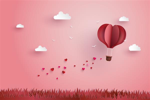 تصویری از عشق و روز ولنتاین اوریگامی ساخت بالون هوای گرم در حال پرواز بر فراز چمن با قلب شناور در آسمان هنر کاغذی و سبک کاردستی دیجیتال