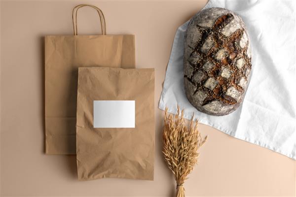کیسه های خرید کاغذی خالی با نان ماکت مارک نانوایی فضای خالی برای نمایش لوگو یا طرح خود را بسازید