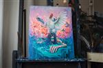 Photo of surreal acrylic painting on black easel in artist