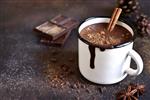شکلات داغ تند خانگی با دارچین در لیوان روی صفحه سنگ